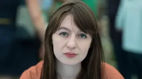 The acclaimed novelist states she is unable to travel to the UK because of arrest fears